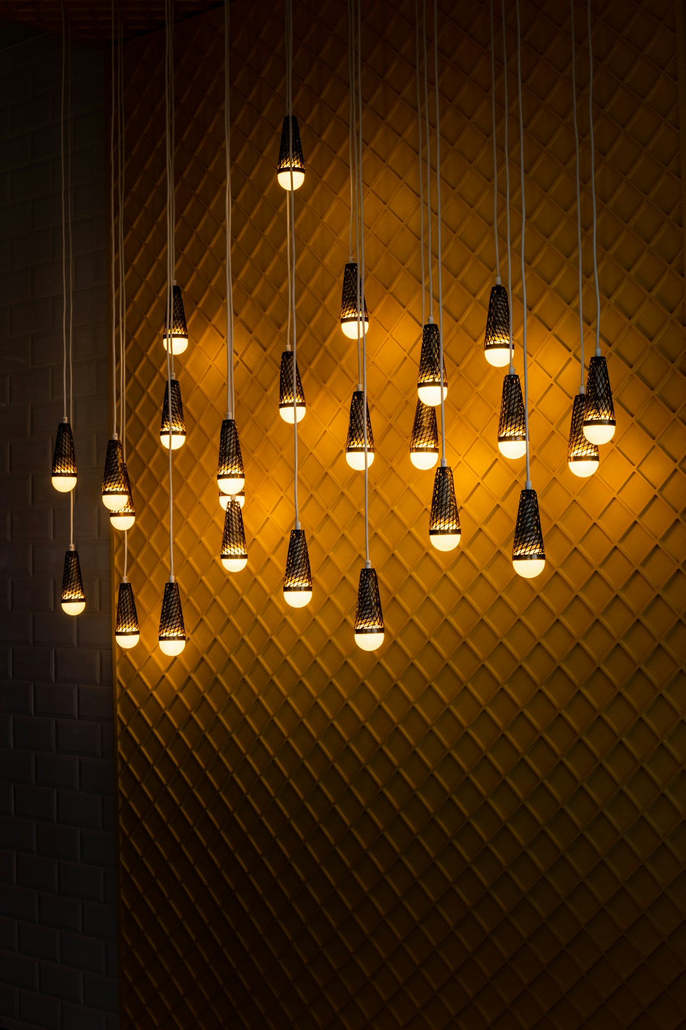 Warm pendant lights in a dark room